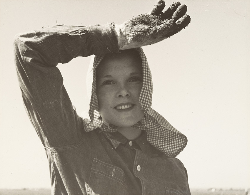 Dorothea Lange_Edison, Kern County, California. Young girl looks up from her work. She picks and sacks potatoes on large-scale ranch